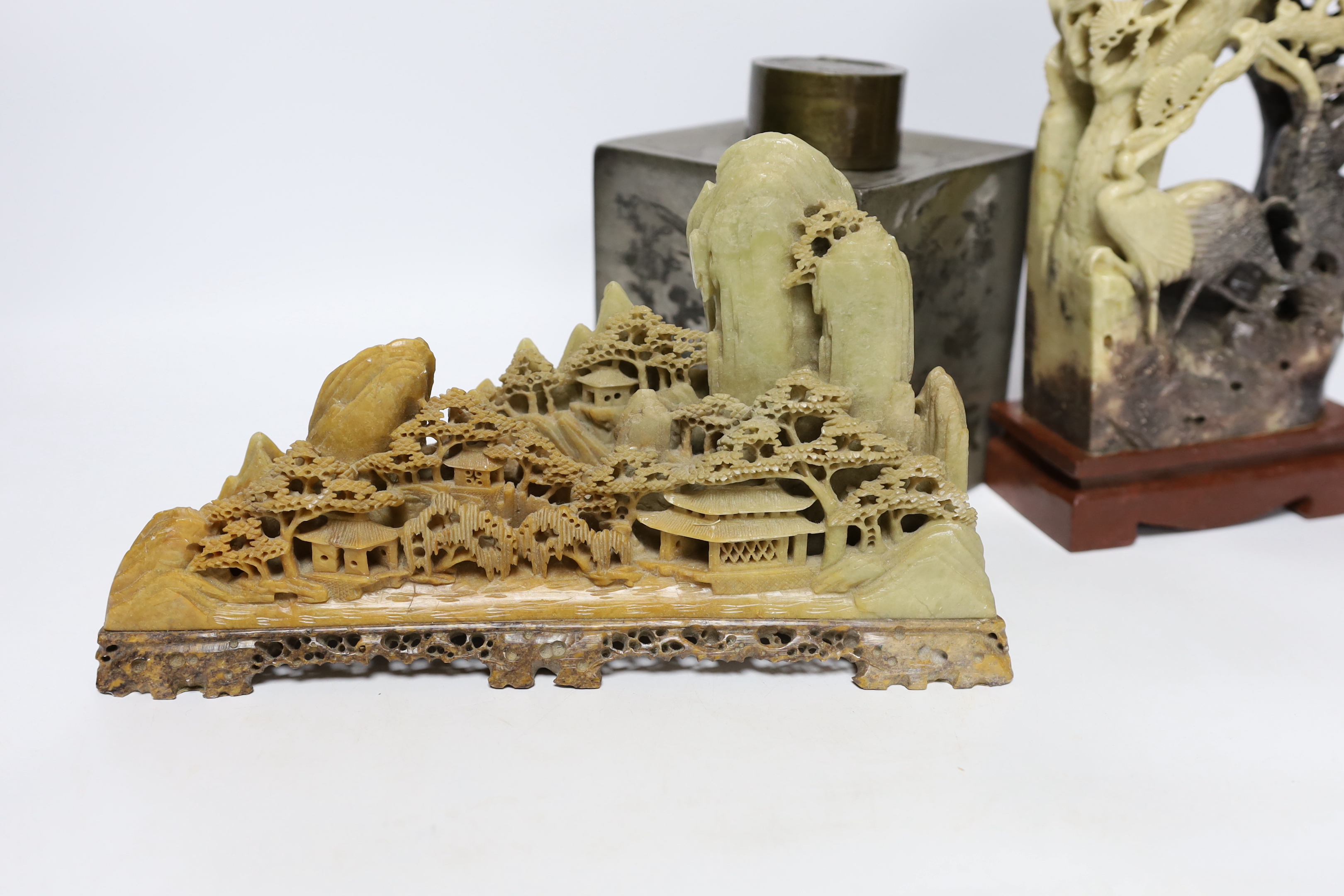 Two Chinese soapstone carvings and a pewter tea canister decorated with birds, largest 24cm high